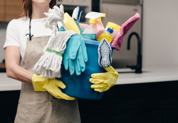 45.holding-bucket-of-cleaning-supplies